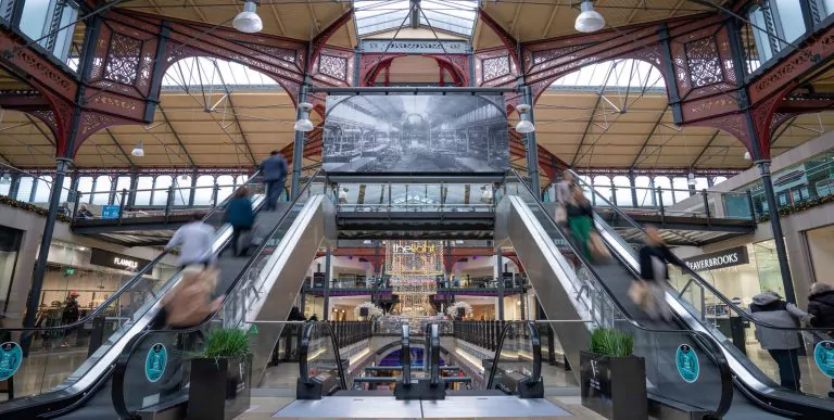 Entrance of Marketplace Shopping Centre with people on escalators